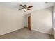 Neutral bedroom featuring a ceiling fan, neutral walls and carpet, and a window at 210 Wentworth Ter, Alpharetta, GA 30022
