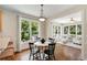 Bright breakfast nook with hardwood floors, large windows and adjacent sunroom at 210 Wentworth Ter, Alpharetta, GA 30022