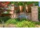 Charming brick community entrance with lush landscaping and decorative Wentworth sign at 210 Wentworth Ter, Alpharetta, GA 30022