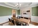 Elegant dining room with large windows, stylish lighting, and hardwood floors at 210 Wentworth Ter, Alpharetta, GA 30022
