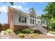 Back exterior of home featuring a large deck, landscaped yard, and patio at 210 Wentworth Ter, Alpharetta, GA 30022