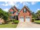 Charming two-story brick home with a well-manicured lawn and a two-car garage at 210 Wentworth Ter, Alpharetta, GA 30022