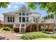 Exterior view of home featuring a back deck and patio and well-maintained landscaping at 210 Wentworth Ter, Alpharetta, GA 30022