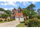 Well-maintained brick home with lush landscaping, inviting curb appeal, and a two-car garage at 210 Wentworth Ter, Alpharetta, GA 30022