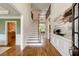 Grand foyer featuring hardwood floors, staircase, wainscoting, and views into other rooms at 210 Wentworth Ter, Alpharetta, GA 30022