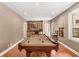Bright game room with a billiard table, and a wet bar area perfect for entertaining guests at 210 Wentworth Ter, Alpharetta, GA 30022