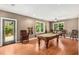 Spacious game room features a pool table, hardwood floors, and natural light at 210 Wentworth Ter, Alpharetta, GA 30022