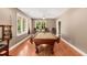 Bright game room with a billiard table, hardwood floors, and plenty of natural light from the windows at 210 Wentworth Ter, Alpharetta, GA 30022