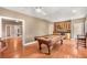 Recreational game room with a billiard table, bar, and hardwood floors, perfect for entertaining guests at 210 Wentworth Ter, Alpharetta, GA 30022