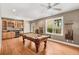 Entertaining game room with pool table, bar area, and ample natural light perfect for hosting guests at 210 Wentworth Ter, Alpharetta, GA 30022