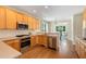 Well-lit kitchen featuring stainless steel appliances and ample cabinet space at 210 Wentworth Ter, Alpharetta, GA 30022