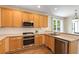 Well-lit kitchen featuring stainless steel appliances and ample cabinet space at 210 Wentworth Ter, Alpharetta, GA 30022