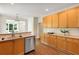 Bright kitchen featuring stainless steel appliances, wood floors, and ample cabinet space at 210 Wentworth Ter, Alpharetta, GA 30022
