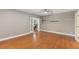 Bright living room with hardwood floors, double doors, and a ceiling fan at 210 Wentworth Ter, Alpharetta, GA 30022