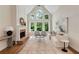 Bright living room featuring fireplace, hardwood floors, tall windows, and ample seating at 210 Wentworth Ter, Alpharetta, GA 30022