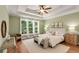 Bright main bedroom boasting tray ceiling, large windows, and ensuite bathroom access at 210 Wentworth Ter, Alpharetta, GA 30022