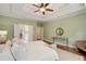 Spacious main bedroom featuring a tray ceiling, an ensuite bathroom, and plenty of natural light at 210 Wentworth Ter, Alpharetta, GA 30022