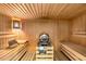 Interior view of a sauna room showing a wooden sauna with heater and bench seating at 210 Wentworth Ter, Alpharetta, GA 30022