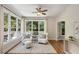 Cozy sunroom with lots of natural light, hardwood floors, and comfortable seating at 210 Wentworth Ter, Alpharetta, GA 30022