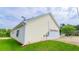 Side view of a home with vinyl siding and a 2-car garage surrounded by a green lawn at 213 Whistle Way, Locust Grove, GA 30248
