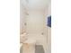 Bright bathroom featuring a toilet, shower-tub combo with marble surround and neutral colored floors at 213 Whistle Way, Locust Grove, GA 30248