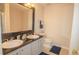 Bathroom featuring double sinks with a decorative mirror and a separate toilet at 213 Whistle Way, Locust Grove, GA 30248