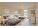 Neutral bedroom featuring hardwood floors, twin beds, overhead lighting and built-in shelving at 213 Whistle Way, Locust Grove, GA 30248
