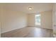 Bedroom featuring hard wood floors, a bright window, and light paint at 213 Whistle Way, Locust Grove, GA 30248