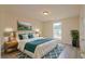 A beautifully decorated main bedroom with a large bed, accent rug, and plant at 213 Whistle Way, Locust Grove, GA 30248