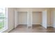 Bedroom featuring two closets with open doors, showcasing the closet spaces, and laminate flooring at 213 Whistle Way, Locust Grove, GA 30248