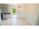 An eat-in kitchen and dining area with wainscoting and views of the private, fenced backyard at 213 Whistle Way, Locust Grove, GA 30248