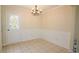 Dining room with wainscoting, chandelier, and tile floor at 213 Whistle Way, Locust Grove, GA 30248