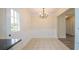 Cozy dining area with neutral tile flooring and a bright white door at 213 Whistle Way, Locust Grove, GA 30248