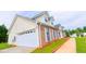 Home featuring a garage, well-maintained front lawn, and manicured landscaping at 213 Whistle Way, Locust Grove, GA 30248