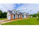 Charming two-story home with brick accents, dormer windows, and well-manicured lawn at 213 Whistle Way, Locust Grove, GA 30248