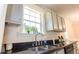 Kitchen with granite countertops, stainless sink and faucet, and white cabinets under the window at 213 Whistle Way, Locust Grove, GA 30248