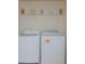 A well-equipped laundry room with modern washer and dryer for convenient chores at 213 Whistle Way, Locust Grove, GA 30248