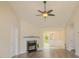 Cozy living room with decorative fireplace, chandelier and dining area at 213 Whistle Way, Locust Grove, GA 30248