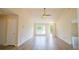 Open-concept living room with vaulted ceilings and gleaming hardwood floors throughout at 213 Whistle Way, Locust Grove, GA 30248