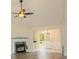 Cozy living room features modern flooring, fireplace, and a fan, flowing to a well-lit area at 213 Whistle Way, Locust Grove, GA 30248