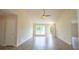 Bright living room featuring wood-look floors, vaulted ceilings, a ceiling fan, and a large window for natural light at 213 Whistle Way, Locust Grove, GA 30248