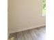 Bright living room with light gray flooring and a large window providing natural light at 213 Whistle Way, Locust Grove, GA 30248