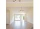 Bright, open-concept living room with high ceilings, ceiling fan, and wood laminate floors at 213 Whistle Way, Locust Grove, GA 30248
