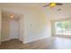 Spacious living room featuring hardwood floors, a ceiling fan, and natural light at 213 Whistle Way, Locust Grove, GA 30248