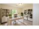 Bright office featuring modern decor, hardwood floors, natural light, and built-in shelves at 213 Whistle Way, Locust Grove, GA 30248