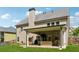 Back exterior featuring a covered patio and expansive backyard with green grass at 2358 Well Springs Dr, Buford, GA 30519