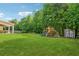 Spacious backyard featuring a playset and storage shed, offering ample space for outdoor activities at 2358 Well Springs Dr, Buford, GA 30519
