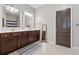 Bathroom with double sinks, dark wood cabinetry, neutral walls, and ample counter space at 2358 Well Springs Dr, Buford, GA 30519