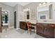 Bathroom featuring double vanities, decorative mirrors, and doorways into other rooms at 2358 Well Springs Dr, Buford, GA 30519
