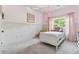 Charming bedroom with pink walls, white wainscoting, and a cozy window seat at 2358 Well Springs Dr, Buford, GA 30519